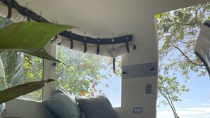 A bedroom with a bed, pillows, and a view of the beach. - Private Beach  experience, 5 minutes from West End (West End)