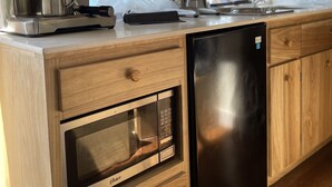 A modern kitchen with a coffee machine, oven, and dishwasher. - Private Beach  experience, 5 minutes from West End (West End)