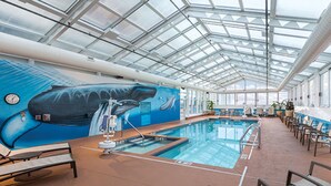 A large indoor swimming pool with a glass ceiling, surrounded by lounge chairs and a mural of a whale. - Two Bedroom Deluxe, Luxury Condo, Atlantic City, NJ  2730150 (Atlantic City)
