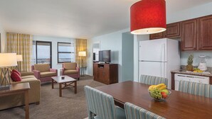 A hotel room with a living area, dining table, and kitchen. - Two Bedroom Deluxe, Luxury Condo, Atlantic City, NJ  2730150 (Atlantic City)