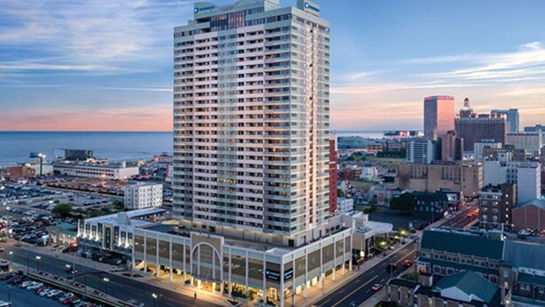 A high-rise hotel with multiple floors, a prominent entrance, and a view of the surrounding cityscape. - Two Bedroom Deluxe, Luxury Condo, Atlantic City, NJ  2730150 (Atlantic City)