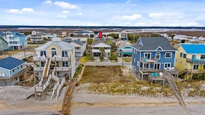 A coastal residential area with houses featuring balconies and a beach in the foreground. - Perfect for Couples and Families - Amazing Ocean View Beach House (North Topsail Beach)