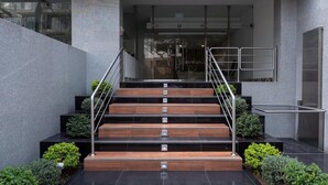 A modern staircase with metal railings and wooden steps leading to an entrance. - Modern 1Bd Apt in the Best of Barranco Miraflores (Lima)