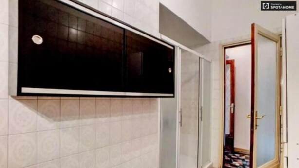 A bathroom with a large mirror, a towel rack, and a shower area. -  CITY CENTER HOUSE (Milan)