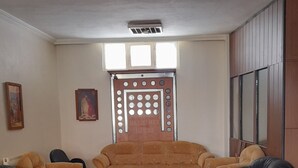 A living room with a sofa set, a coffee table, and a decorative panel with text.
