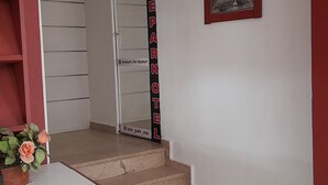 A hotel entrance with a staircase leading to a room.
