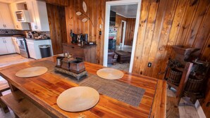 A wooden kitchen with a central island, a microwave, and a coffee machine.