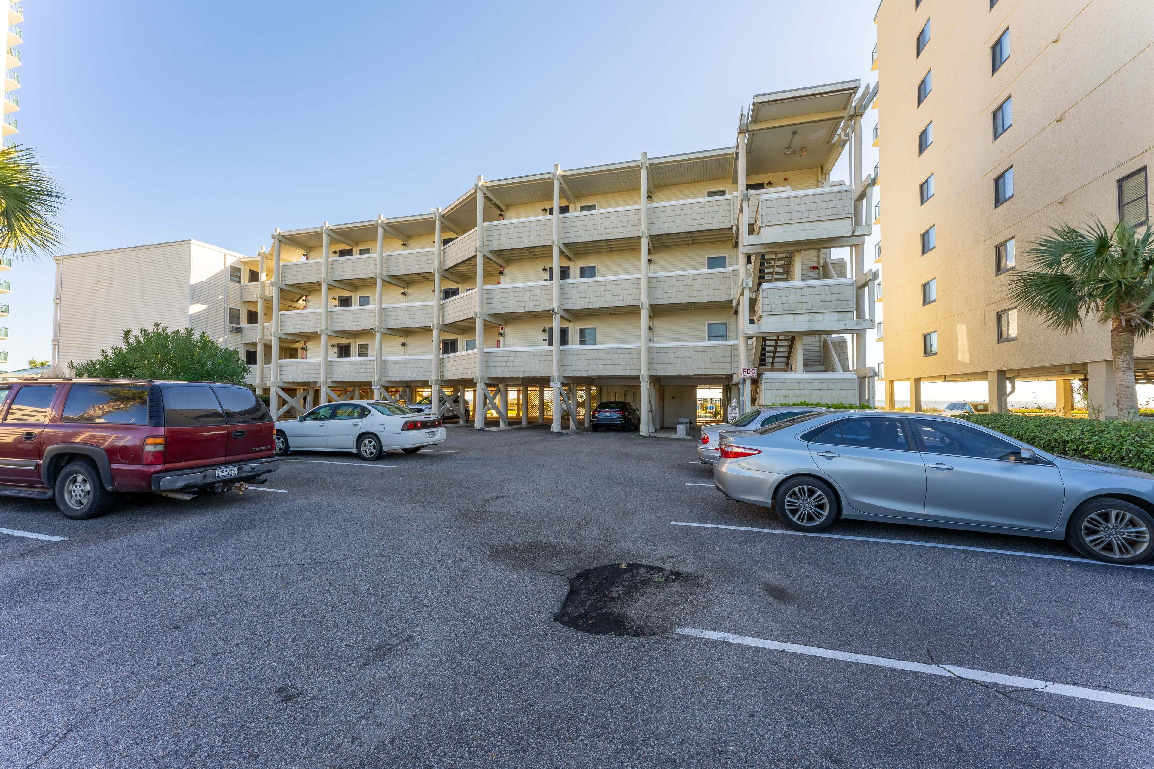 A multi-story parking garage with several cars parked.