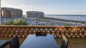 A balcony with a view of the beach and hotel buildings. - Ocean View Condo at Pool-Beach and Golf Resort with Concierge, Maids and Chef - Meal Services (La Paz)