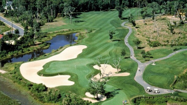 A golf course with sand bunkers, water hazards, and a pond. - Book with an owner not a management company-personalized service! Great reviews (Pawleys Island)