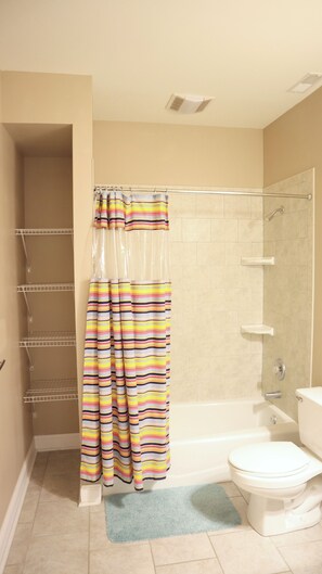 A bathroom with a shower, toilet, and a towel rack. - Modern 6 Bedroom Wildwood Beach Getaway (Wildwood Crest)
