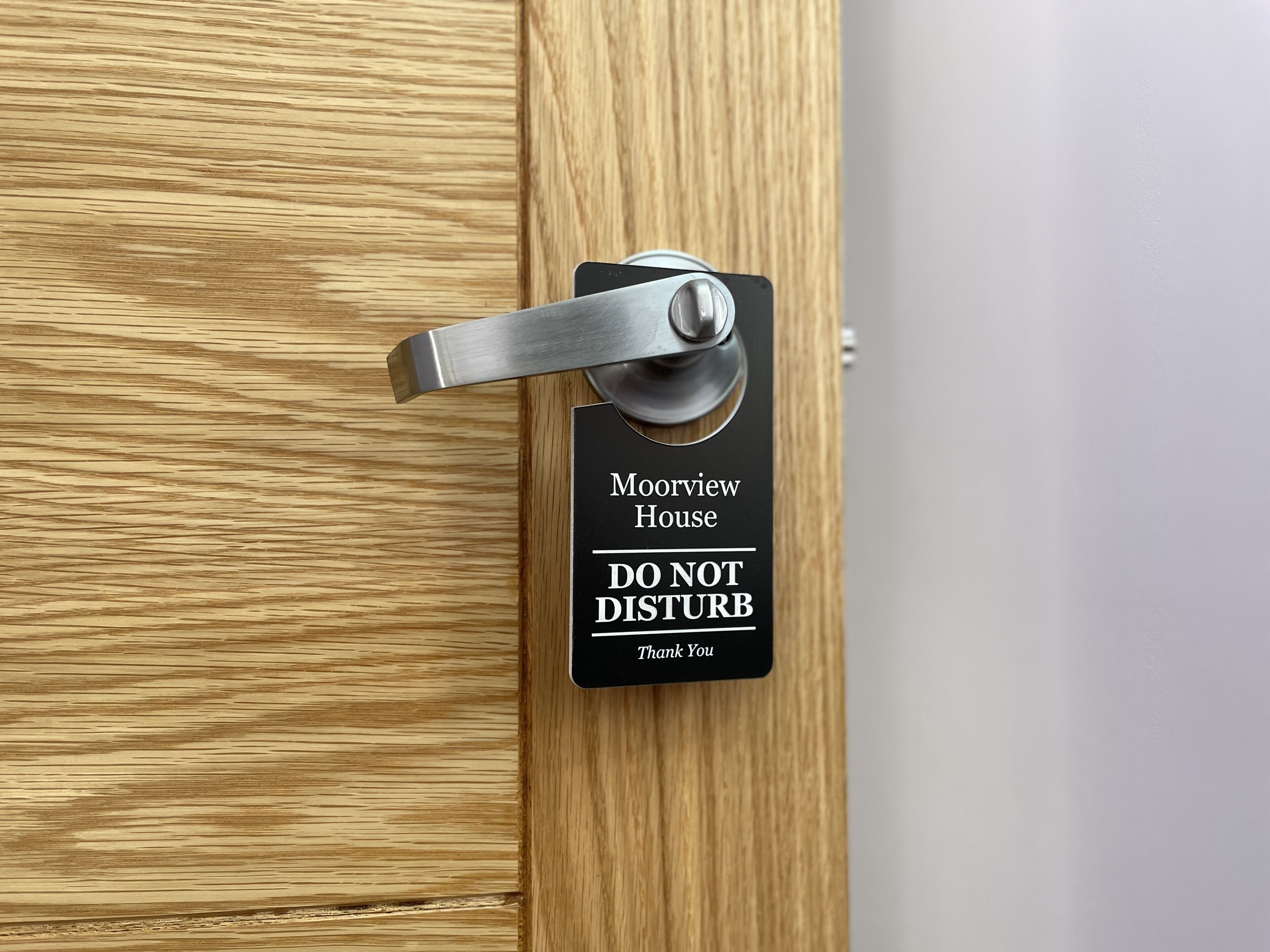 A door with a sign that reads "Mooview House DO NOT DISTURB Thank You".