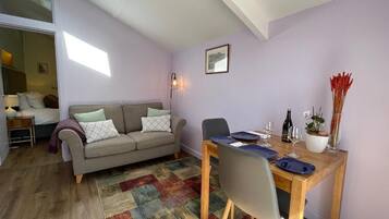 Deluxe Studio Suite, Garden View | Living area | 45-inch Smart TV with digital channels, TV