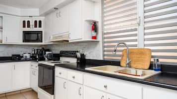 Microwave, coffee/tea maker, spices, cleaning supplies