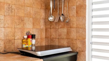 Microwave, coffee/tea maker, spices, cleaning supplies