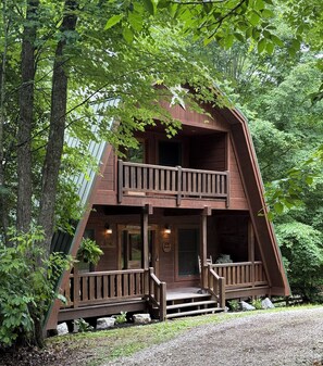 A cabin with a two-story balcony, a porch, and a sign that reads 'Weekend Retreat.' - Big South Fork! Peaceful, Relaxing, On the Trails…Six Decks ~ Nature’s Paradise! (Strunk)