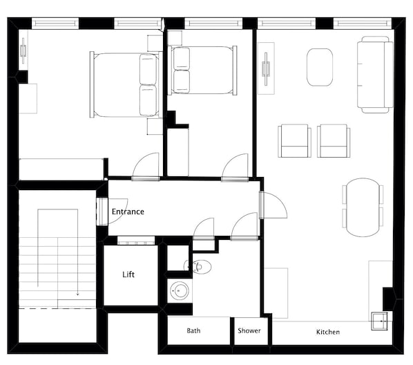 A floor plan of a hotel with a lift, entrance, bathroom, shower, and kitchen.