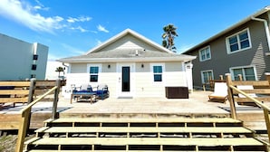 A house with a front porch, a door, and a small front yard.