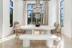 Enjoy meals in this dining area with a round table and wicker chairs.