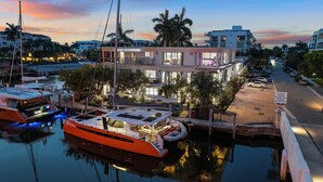 A waterfront hotel with a modern design, featuring multiple balconies and large windows. - Isle of Venice (Fort Lauderdale)