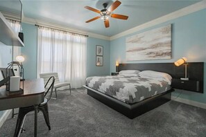 A bedroom with a bed, a desk, a chair, a ceiling fan, and a window with curtains. - Coastal Condo w/ Pool, Balconies, Sundeck & Boat Slip - Near Beach (Corpus Christi)