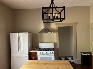 Enjoy meals in the kitchen with a gas stove, refrigerator, and dining area.