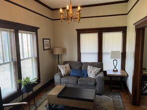 Relax in this inviting living room with a large sofa, coffee table, and floor lamp.