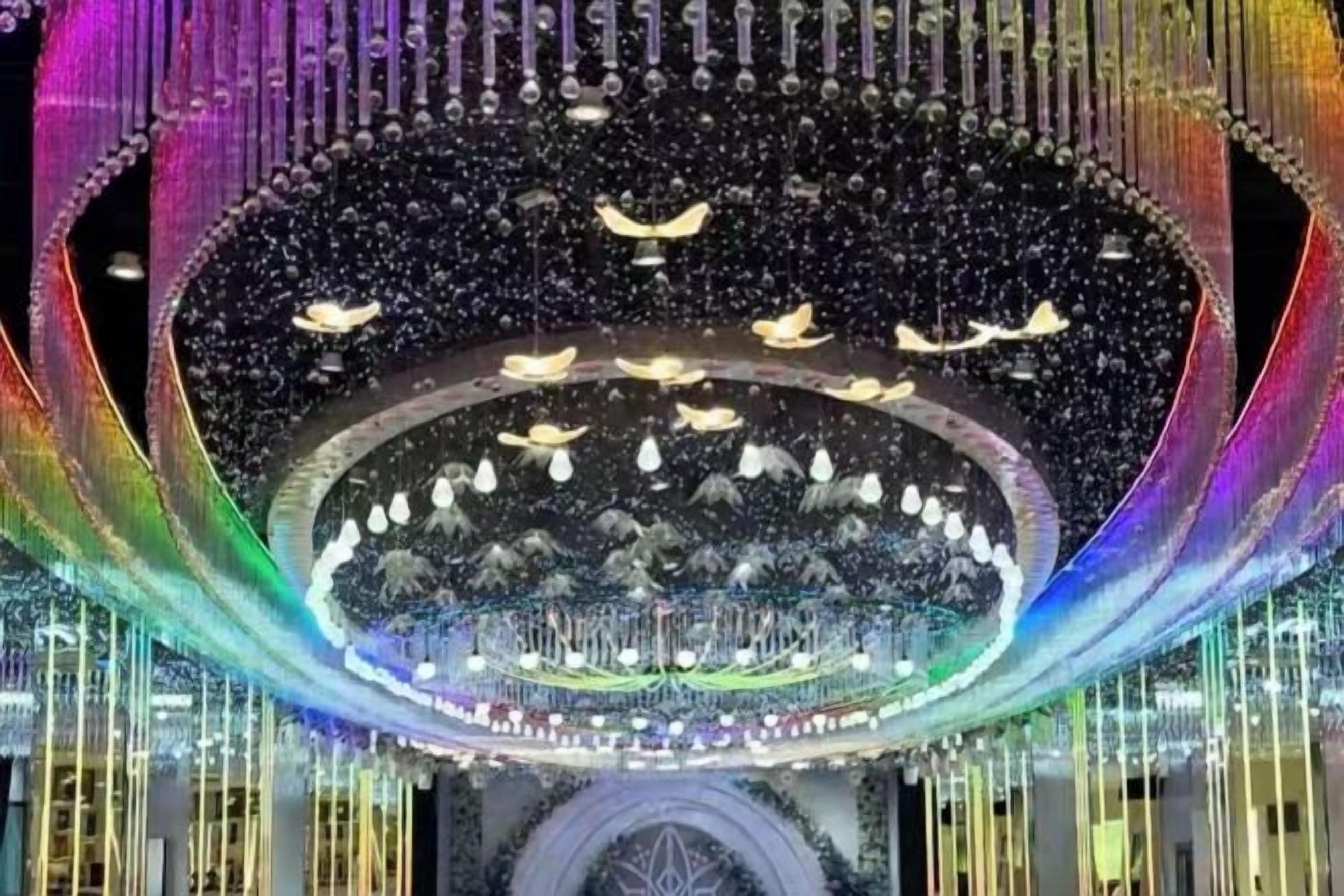 A large, circular architectural structure with a central open area surrounded by a patterned design.