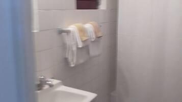Combined shower/bathtub, towels, soap, toilet paper