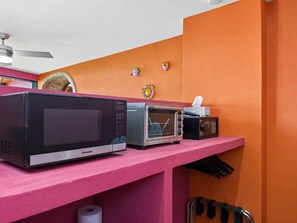 A kitchenette with a microwave, toaster, and a small refrigerator. - Miguel's Mirador: Ocean-View Studio, Hammock Terrace, Heated Pool, Walkable (Puerto Vallarta)