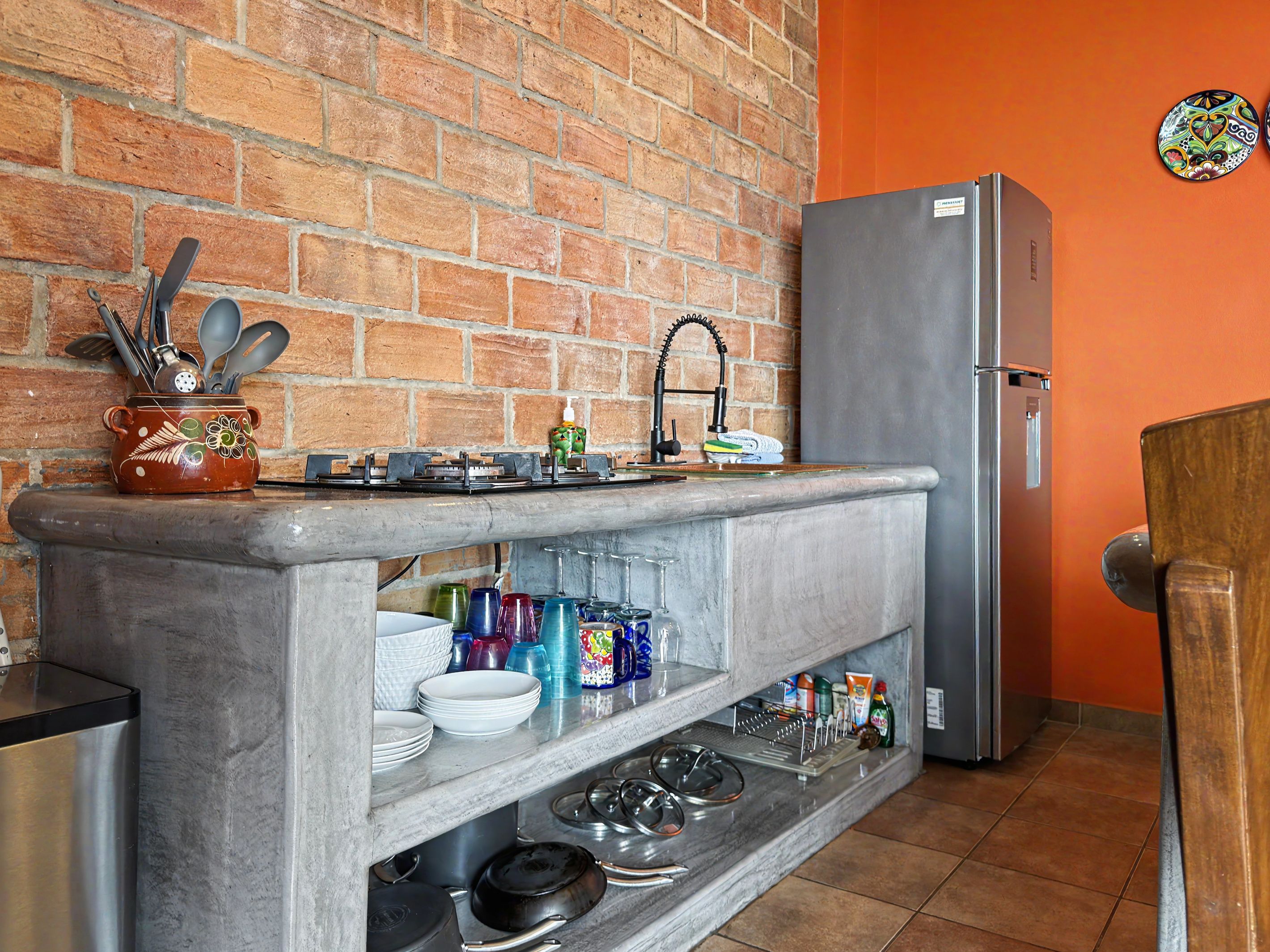 Ivan's Bella Vista kitchen: dishes, glassware and cookware on open shelves