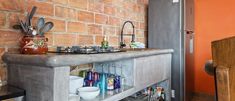 Ivan's Bella Vista kitchen: dishes, glassware and cookware on open shelves