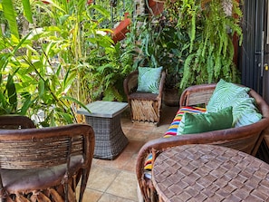 Curiel's Retreat terrace: equipal chairs among the greenery