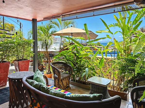 Curiel's Retreat terrace: steps from the pool, with a glimpse of the bay