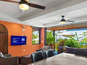 Curiel's Retreat: living and dining area, glass doors open to the terrace - Las Brisas: Main-Level 3BR, Private Terrace, Heated Pool, Walk to Malecón (Puerto Vallarta)