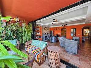 A spacious living area with a kitchen, dining area, and seating arrangements. - Las Brisas: Main-Level 3BR, Private Terrace, Heated Pool, Walk to Malecón (Puerto Vallarta)