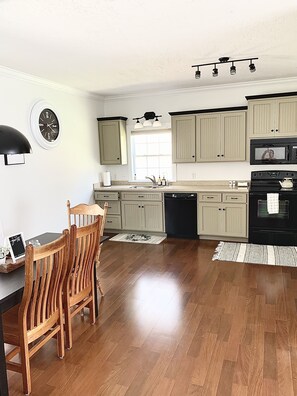 Full size kitchen with oven, dishwasher and side by side refrigerator 