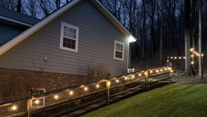 A house with a wooden deck and string lights. - The Relaxing Oaks (Columbus)