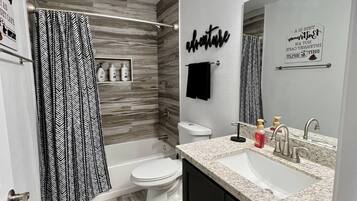 Combined shower/tub, hair dryer, towels, soap