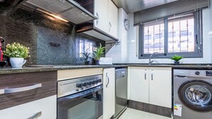 A modern kitchen with a built-in oven, dishwasher, and washing machine. - Vila del Far by Interhome (St Carles de la Ràpita)