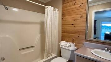 A bathroom with a bathtub, toilet, and sink.