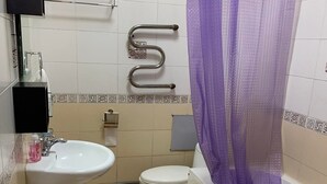 Une salle de bain avec un lavabo, des toilettes et une baignoire.