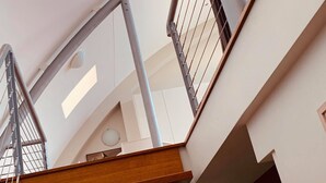A modern interior with a staircase, metal railings, and a wooden floor. - Immaculate designer house-sweeping views over iconic Blueys Beach 3min walk away (Blueys Beach)