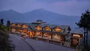 A large, multi-story hotel with a prominent sign reading "JÜSTA CLIFFEND". -  juSTa Cliffend Resort & Spa Mashobra Shimla (Shimla)