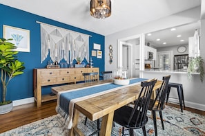 Enjoy meals in this stylish dining area with a long table, comfortable chairs, and a cozy bench.