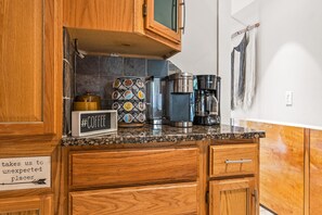 Enjoy cooking in this well-equipped kitchen with a coffee station, oven, and microwave.