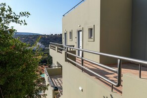 A building with a balcony, a metal railing, and a door. - Sunny Hill by Estia (Hersonissos)