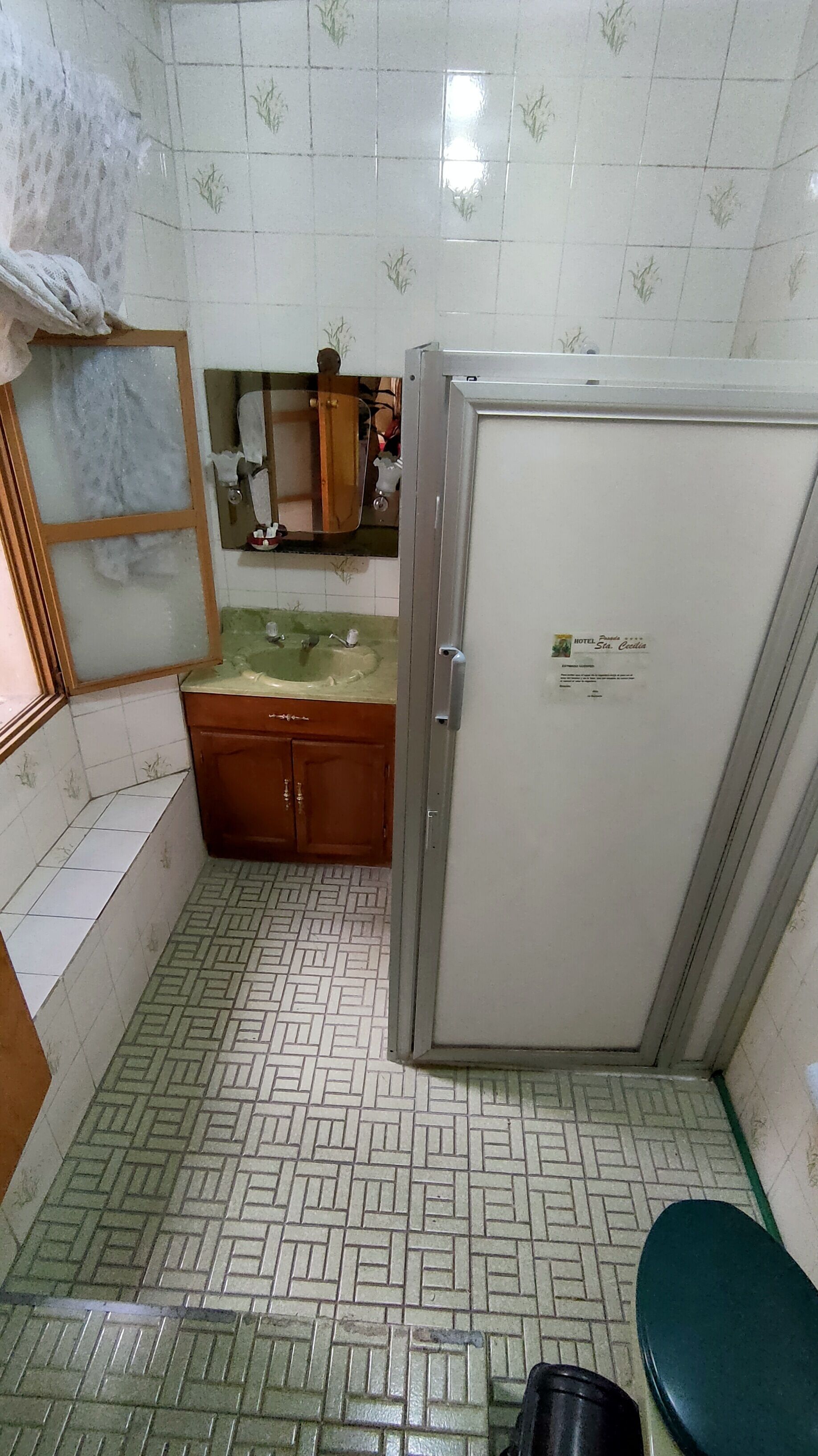 A small bathroom with a toilet, a sink, and a cabinet.