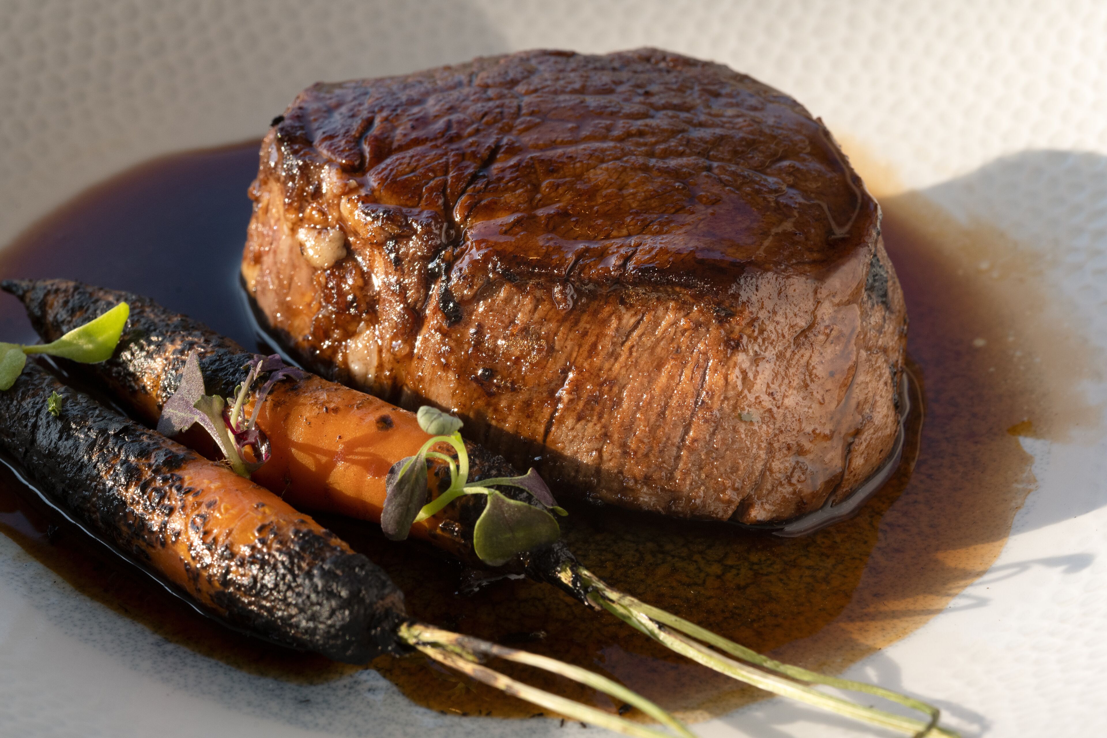 A steak with vegetables on a plate.