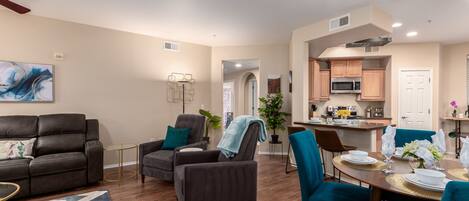 Relax in a stylish living space with a comfortable seating area, dining table, and modern kitchen.